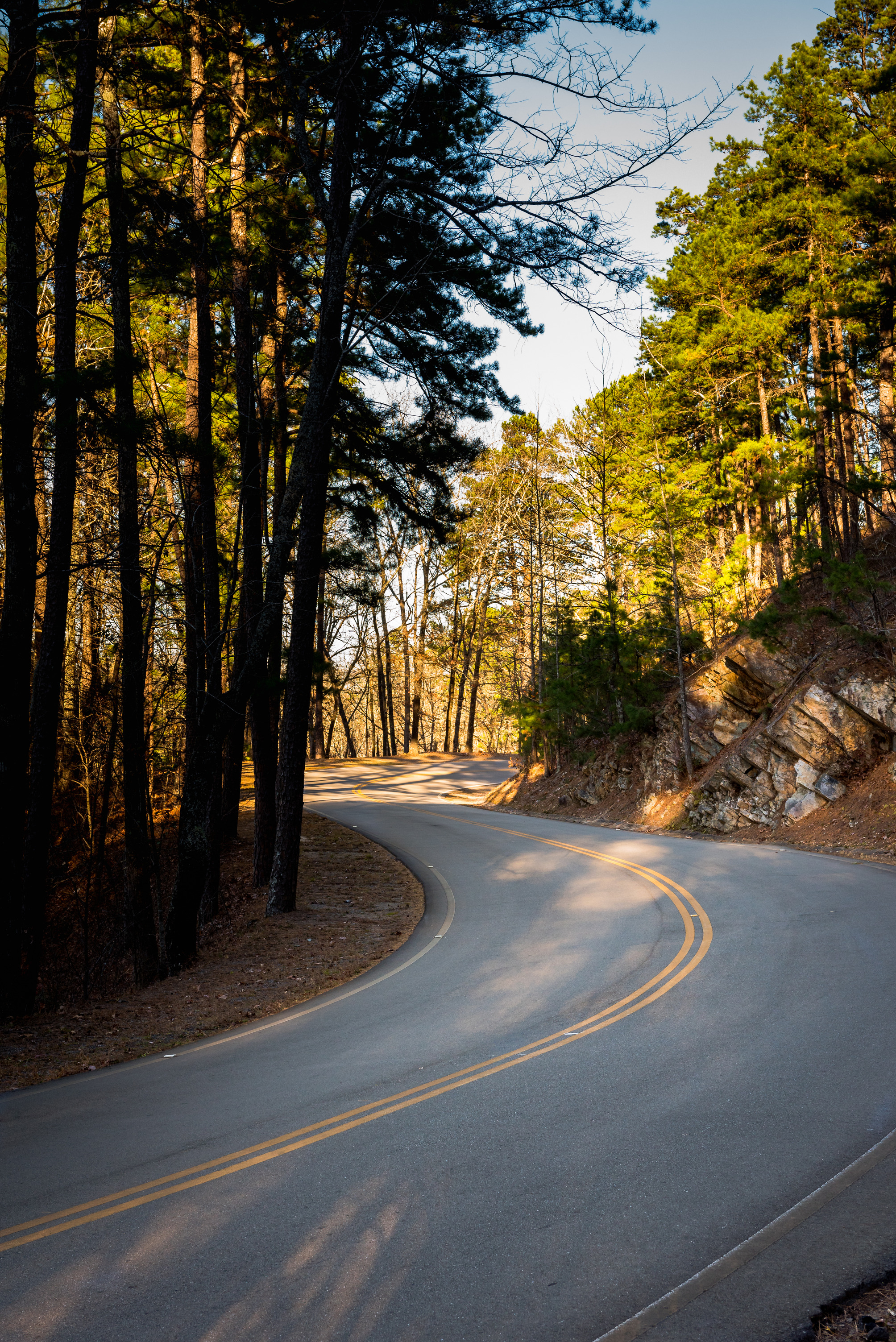 road surrounded by giant rocks and trees