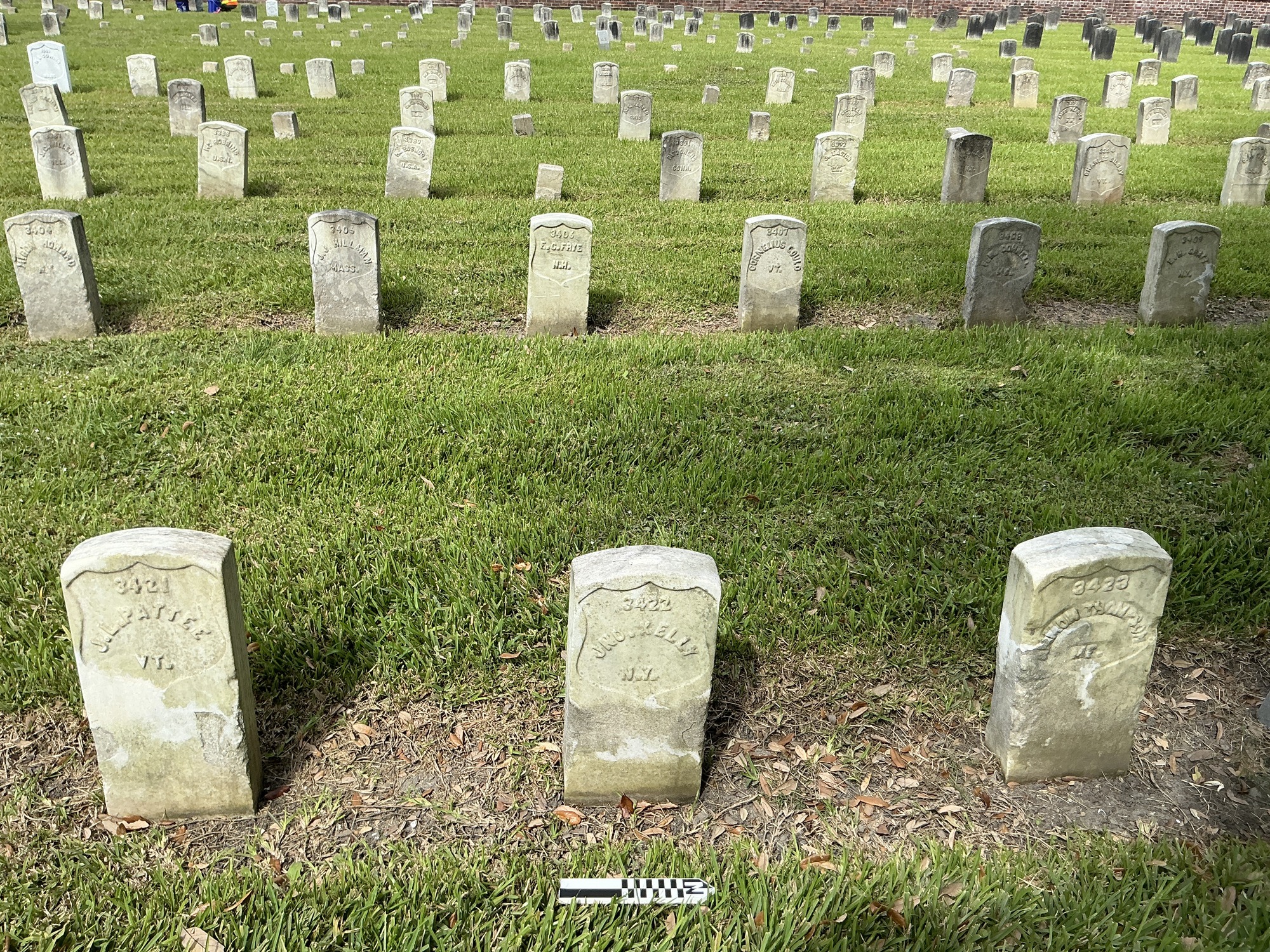 Extra image of historic upright marble headstone with recessed shield face.