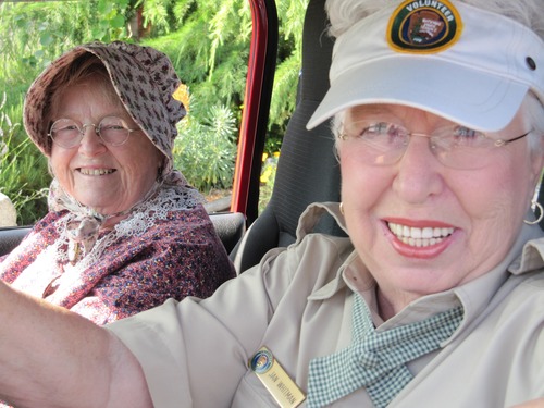 Athlene Schneider and Jan Whitman ride driver and shotgun as part of the park's entry in the 2009 Fourth of July parade, which also celebrated the town's centennial.
