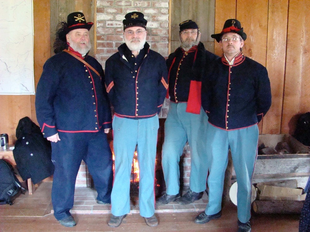 From left: Ron Garner, Oren Combs, Chris DeStaffany and Brad Smith are key members of Battery, the nonprofit foundations that sponsos the Holiday Social and other park living history events.