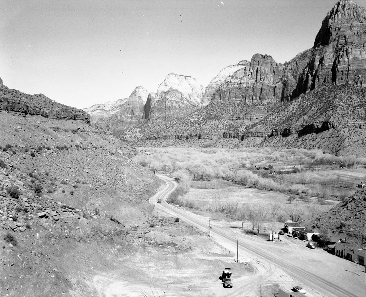 The mouth of Zion Canyon with 'Zionville Market and Motel' in Springdale, Utah (in the foreground), 0.5 mile south Zion National Park South Entrance. Bridge Mountain at far right.