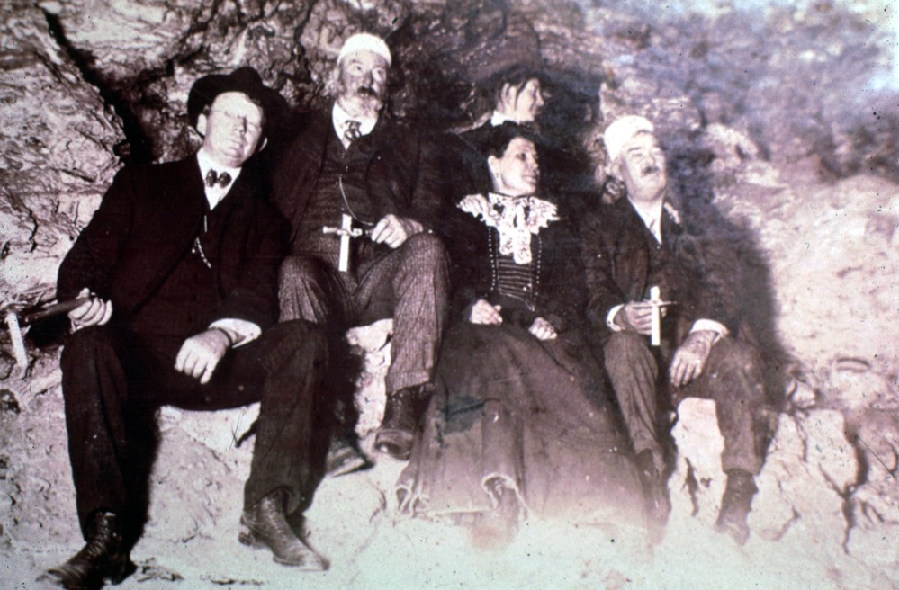 Early tour of Wind Cave, people are holding candles