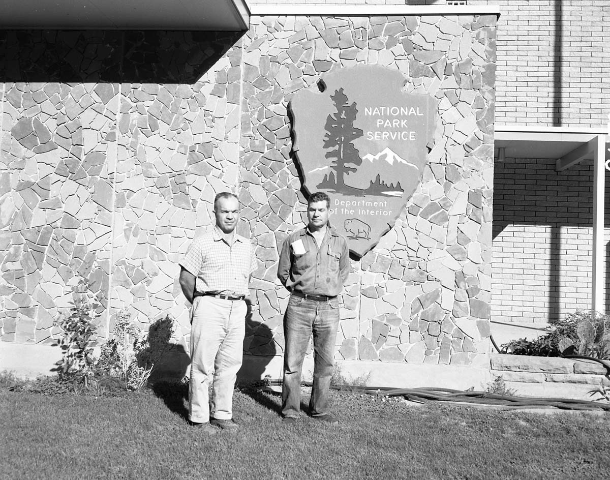 Award recipients standing in front of Mission 66 Visitor Center and Museum: Emil Justet awarded $300 for extraordinary performance of duty, and Wesley Dennett awarded for completion of 20 years of service.