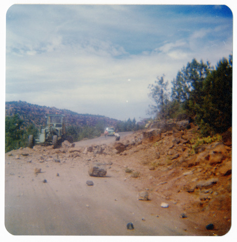 Rock pile across road with men working to clear it along the Kolob Terrace Road.