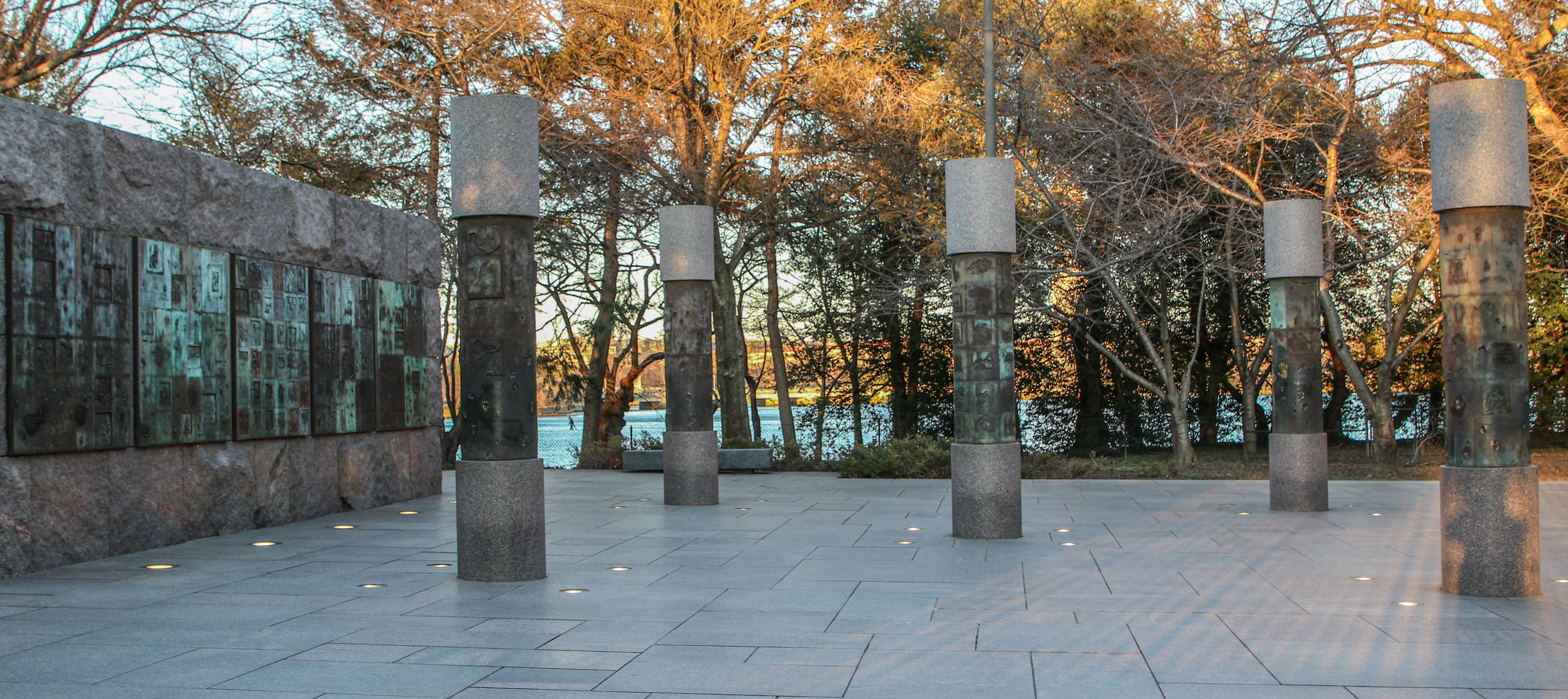 Stone wall and columns with engraved metal panels