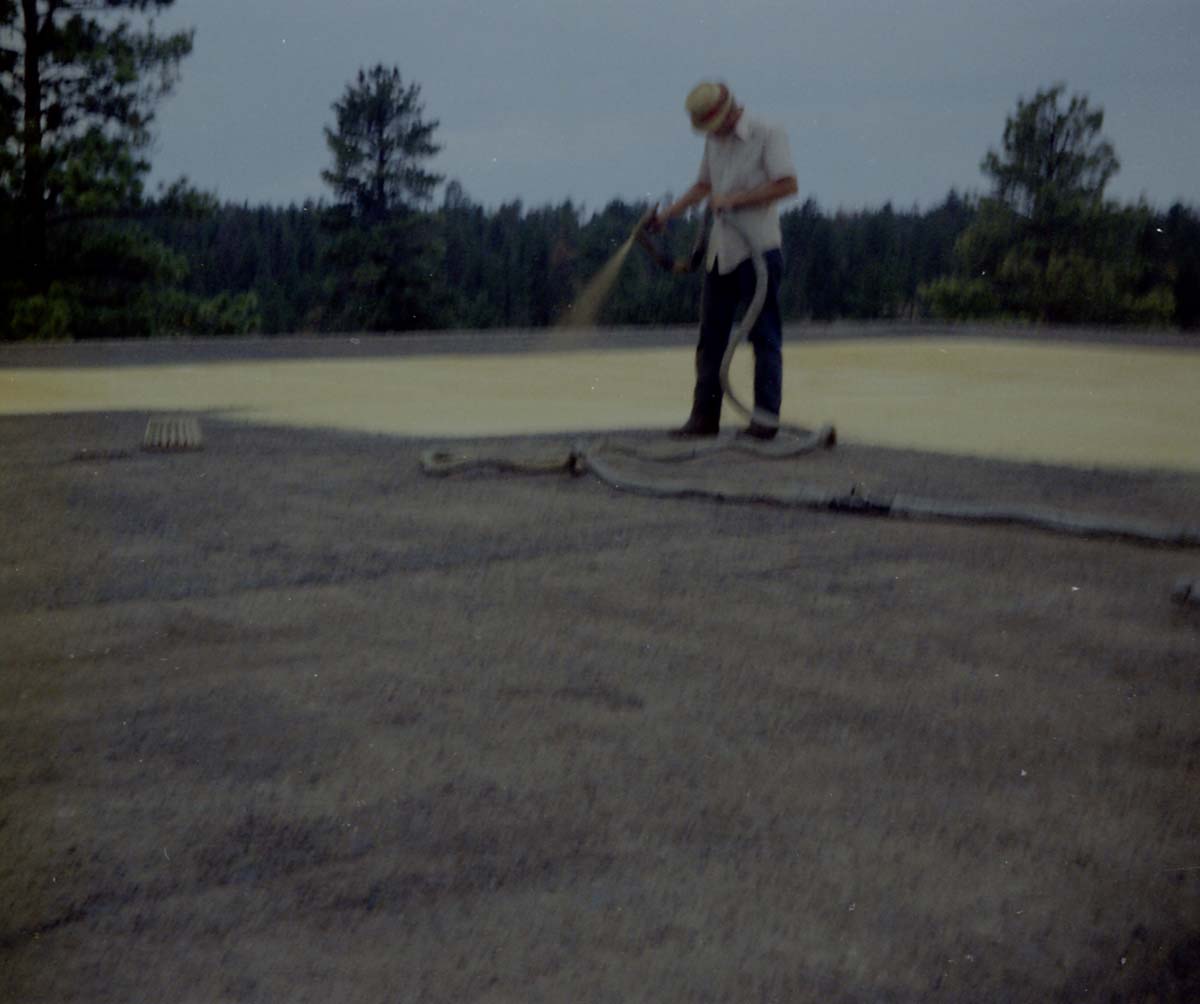 Man spraying foam sealant during reroofing project. Bryce Canyon National Park.