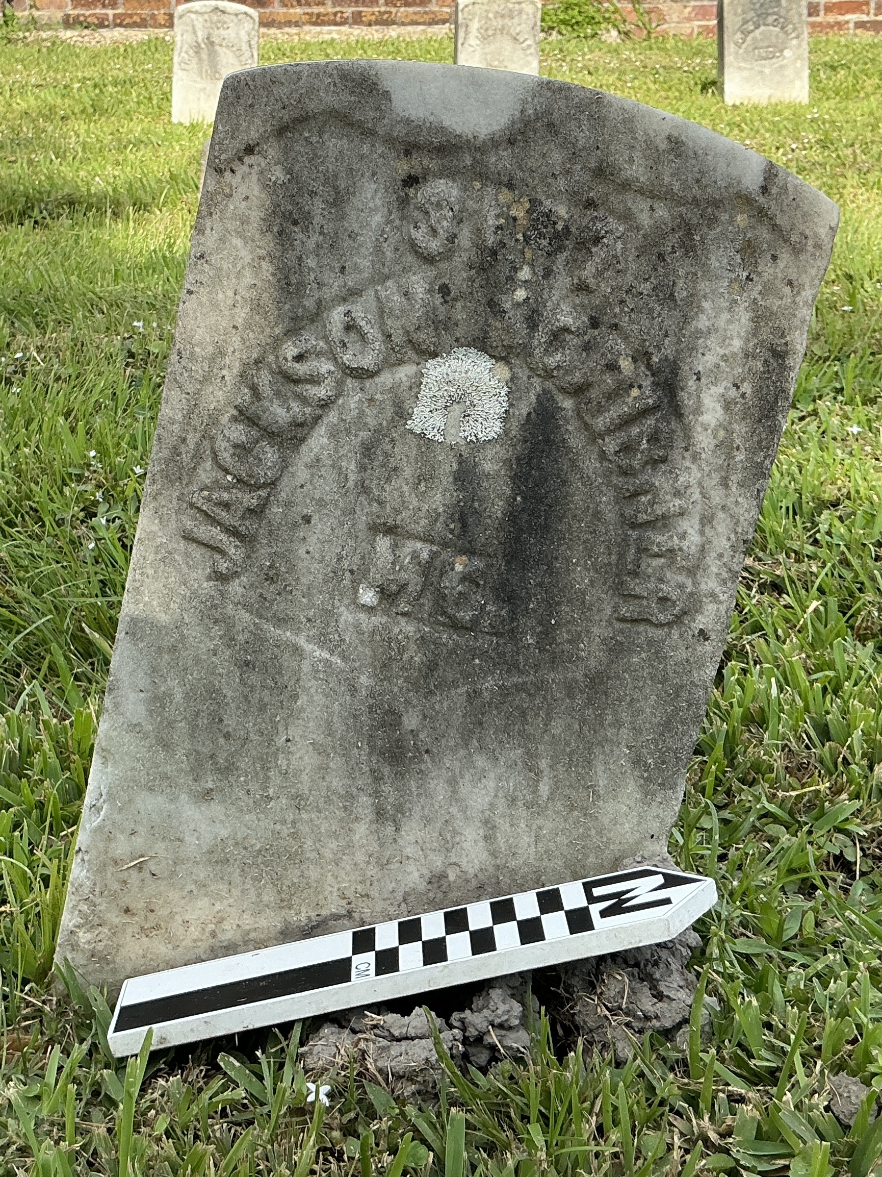 Extra image of historic upright marble headstone with recessed shield with recessed lettering face.