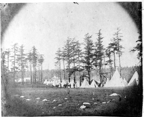 U.S. Army soldiers pose before their "Sibley" tents during the height of the Pig War crisis. The area forms the major portion of today's fenced parade ground (see American Camp Prairie album).