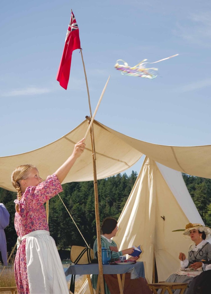 A young re-enactor plays with a 19th century toy during Encampment 2006 at English Camp.