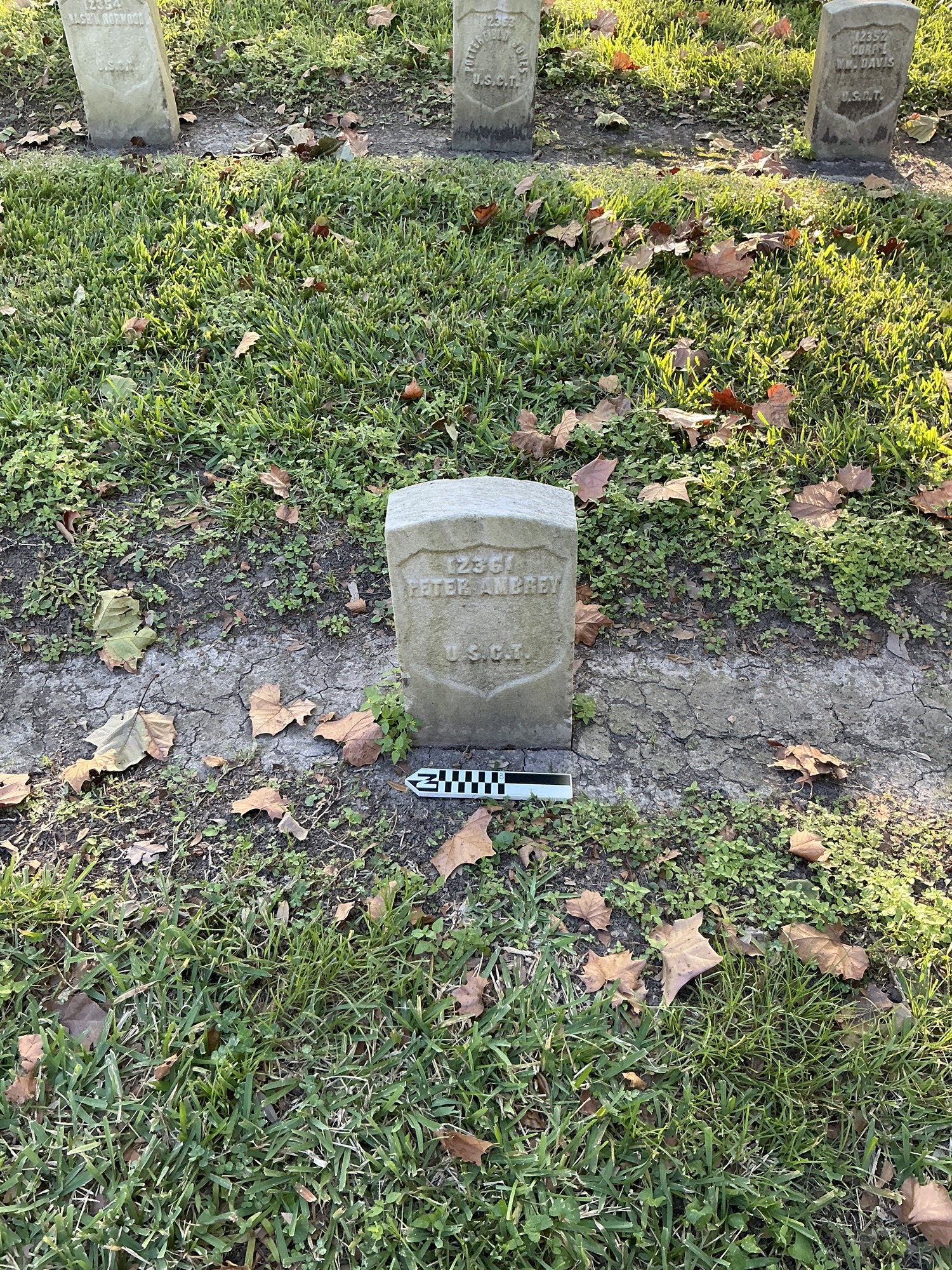 Extra image of historic upright marble headstone with recessed shield face.