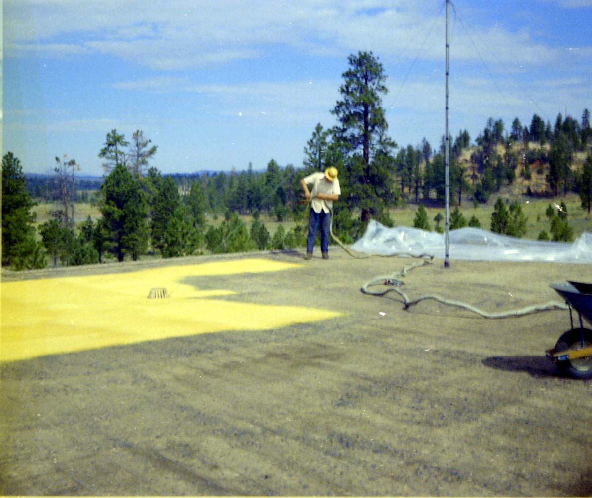 Man spraying foam sealant during reroofing project. Bryce Canyon National Park.