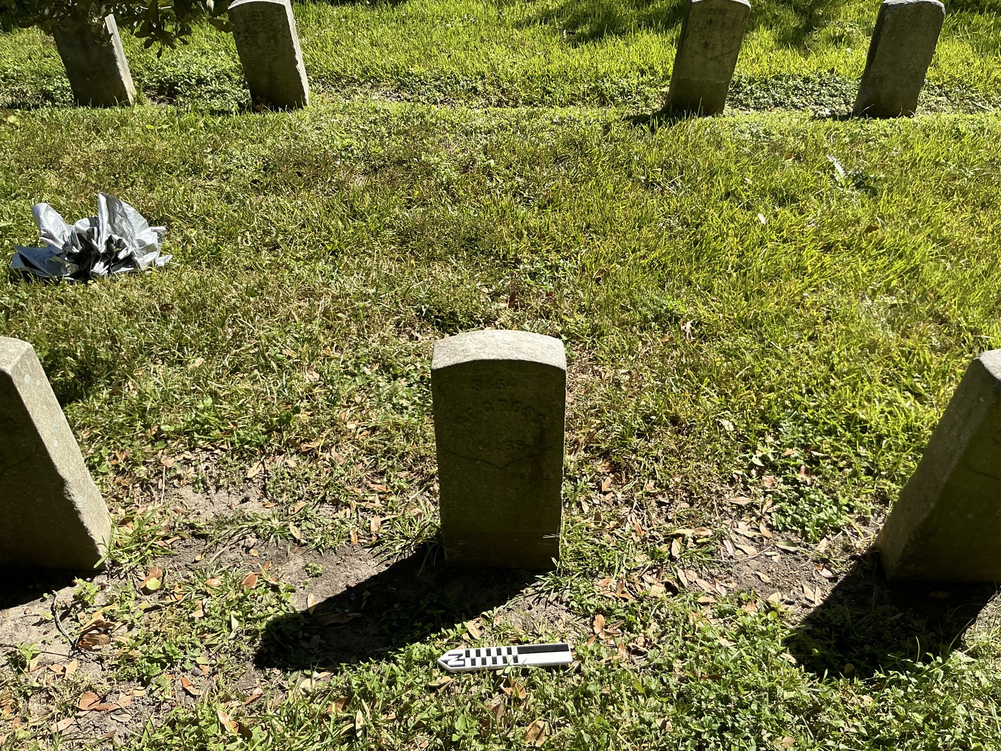 Extra image of historic upright marble headstone with recessed shield face.