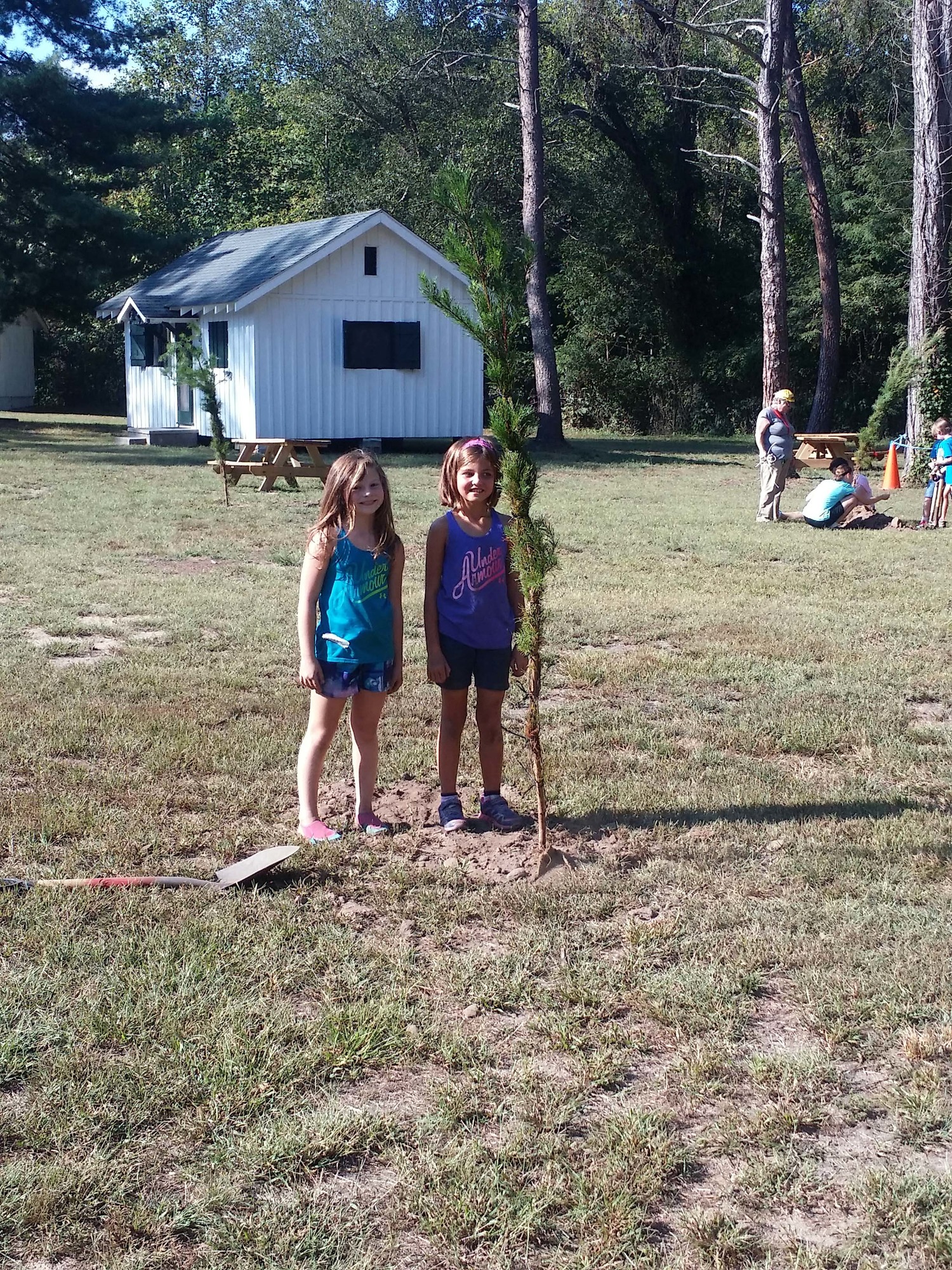 two girls planting a tree