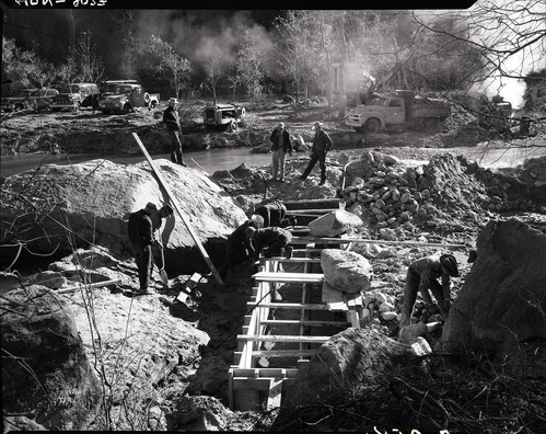 Water supply system - crews and equipment building forms for construction of an underpass for water pipeline beneath Virgin River at the Temple of Sinawava.