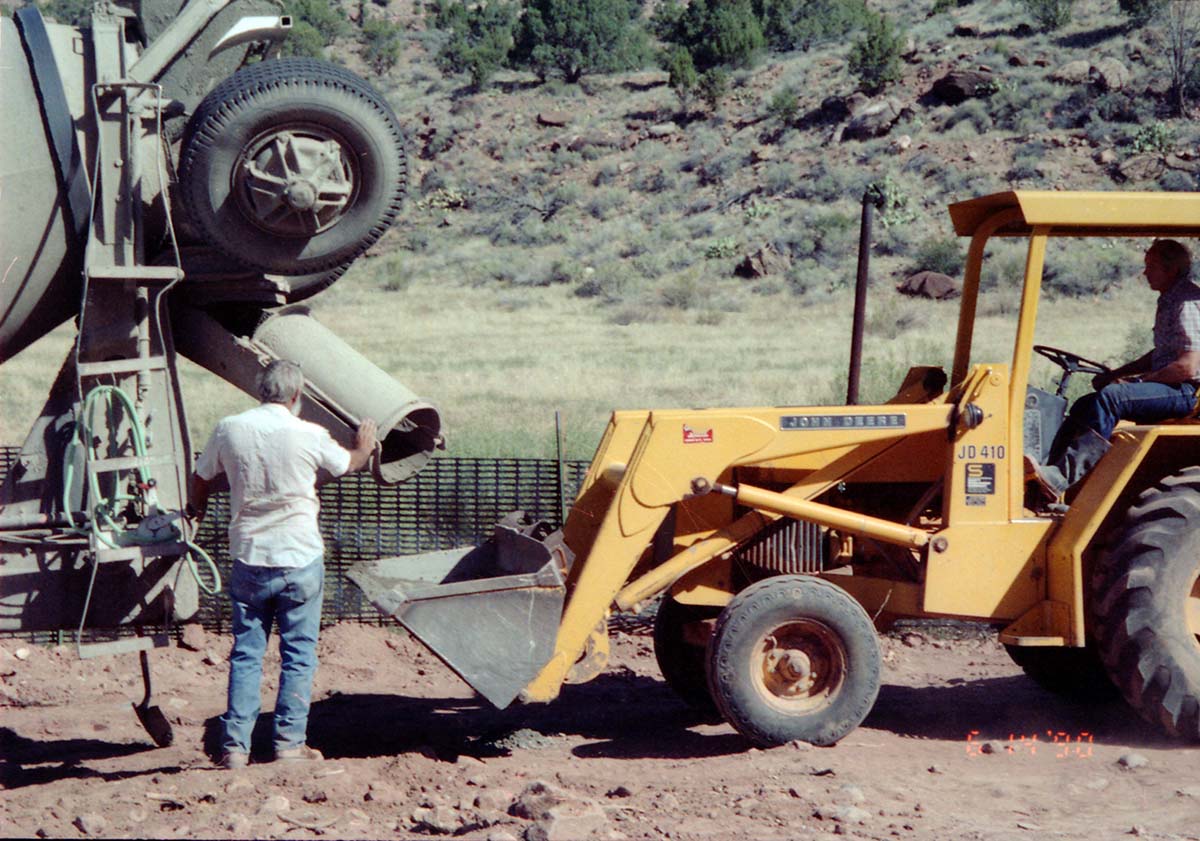 Workers operating construction vehicles during the construction of headquarters addition.
