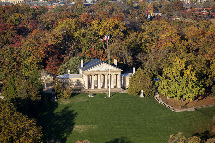 An aerial view of the Arlington House, surrounded by fall-colored trees and a grassy lawn in front of it.