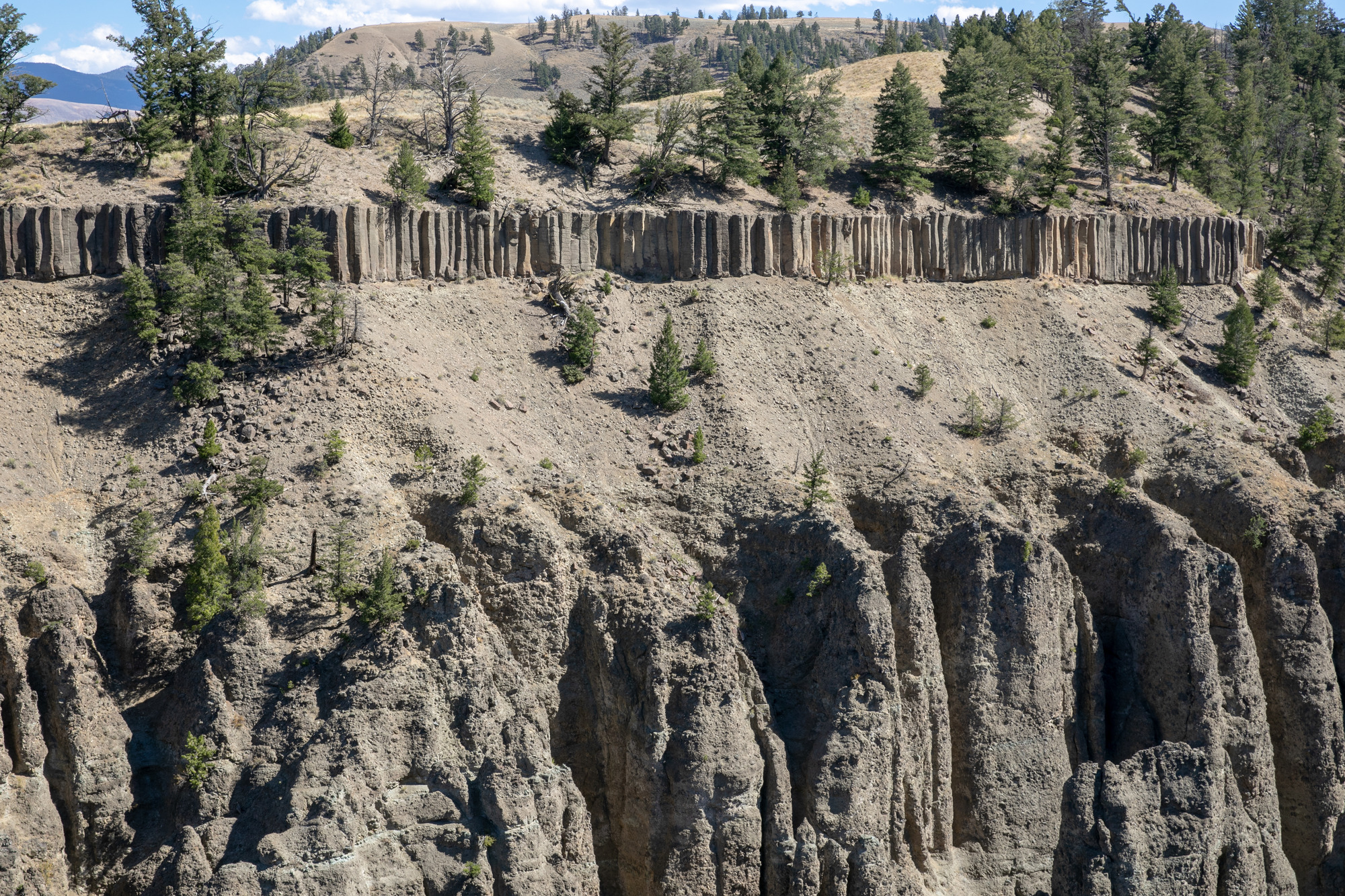 Looking at two distinct layers of rock within a canyon wall.