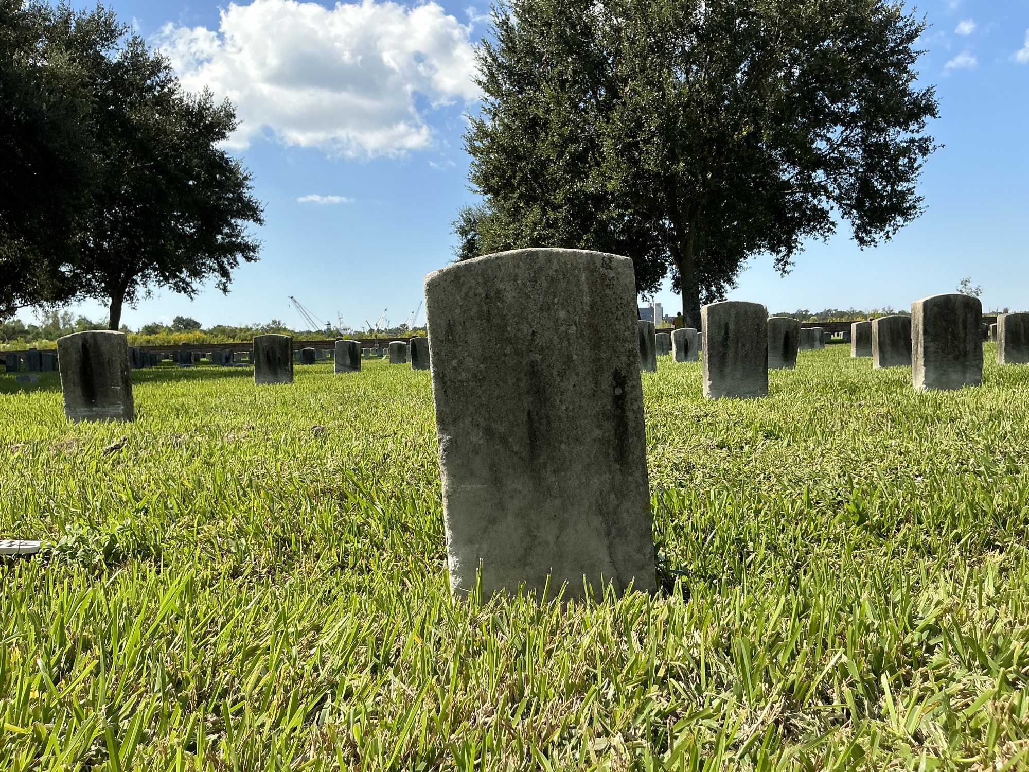 Back of historic upright marble headstone with recessed shield face.
