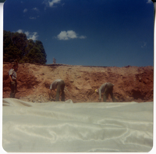 Men using tarp to cover areas of road during road work/repair in Kolob Canyon.