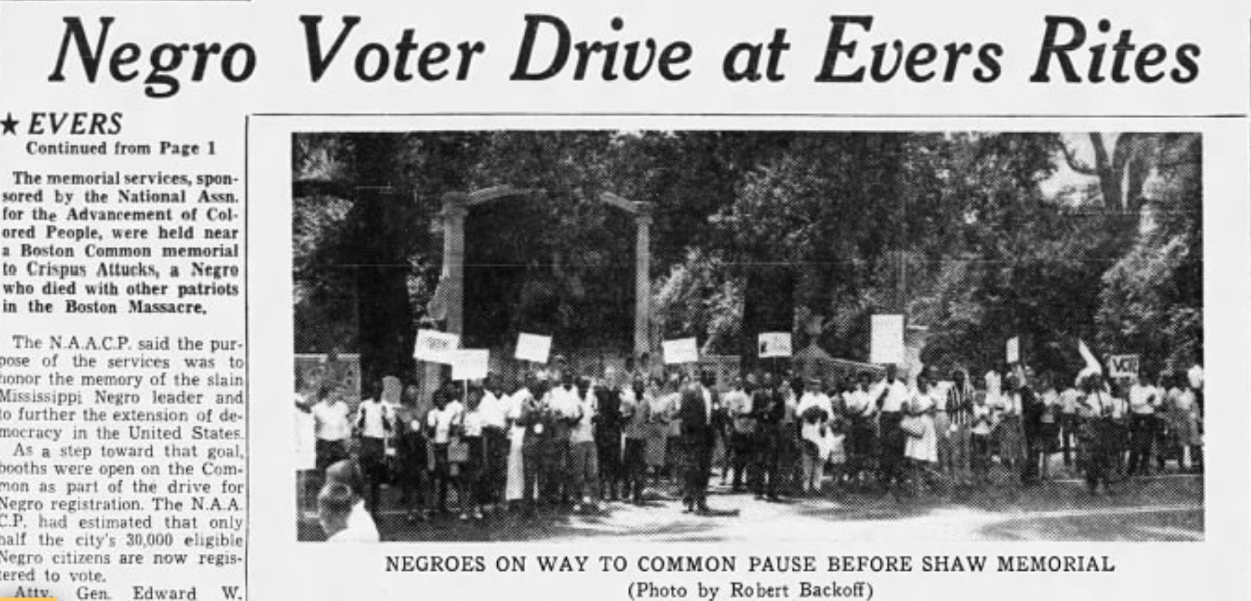 Newspaper article with image of protesters standing in front of the Shaw 54th Regiment Memorial. 