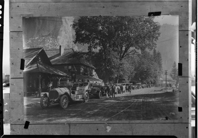 Lineup of auto stages in Old Village. Mr. Patterson in lead car. Man in rear seat looks like president of Santa Fe RR. 1918 (?) by number on license plate. [See also RL-2589 and RL-9856. Slide: 201-SL09-1147].
