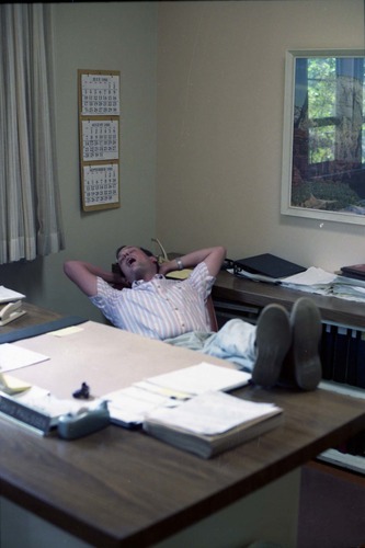 Color Photos of administration personnel. Man pretending to sleep at desk.