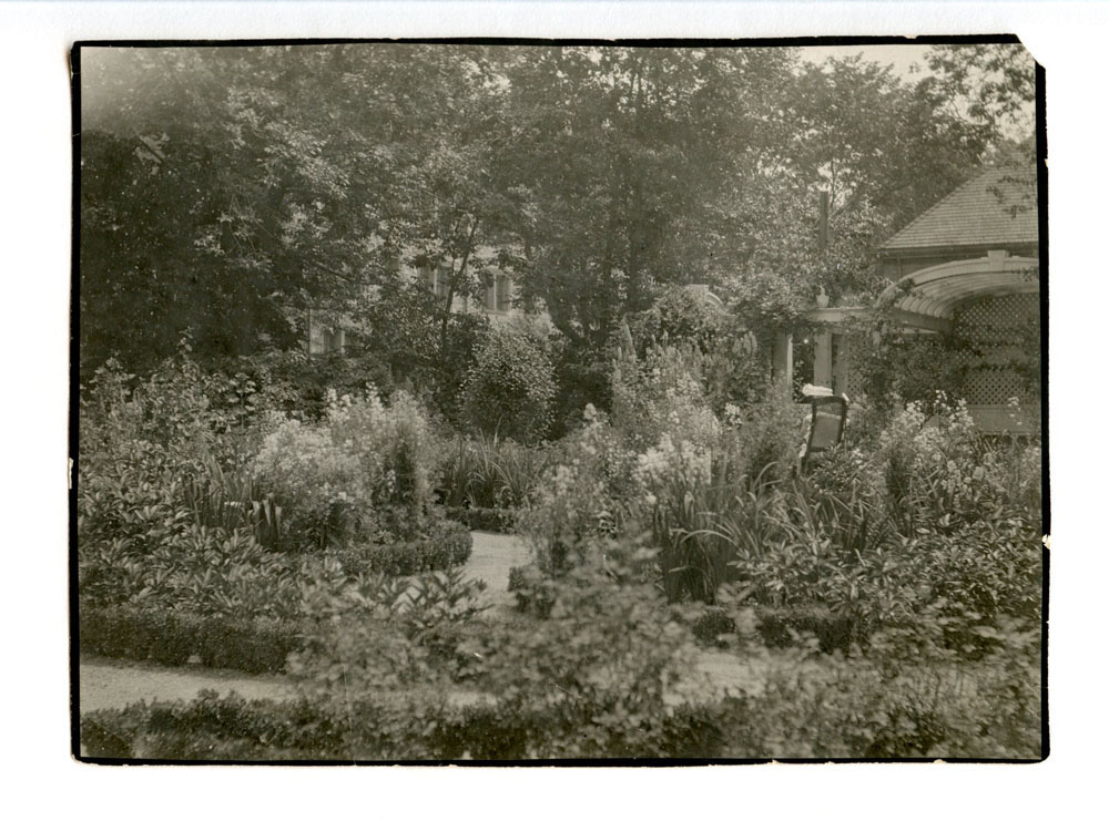 Black and white photograph of formal garden in full bloom.