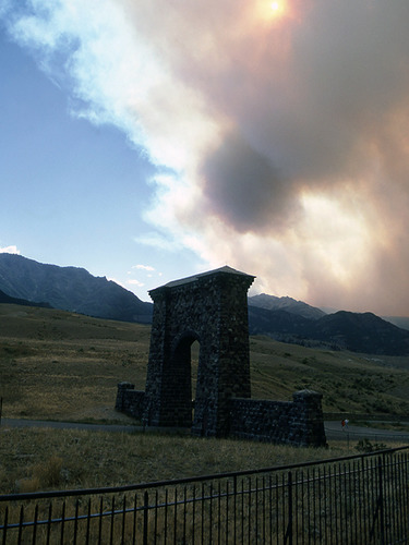 Roosevelt Arch with smoke behind it