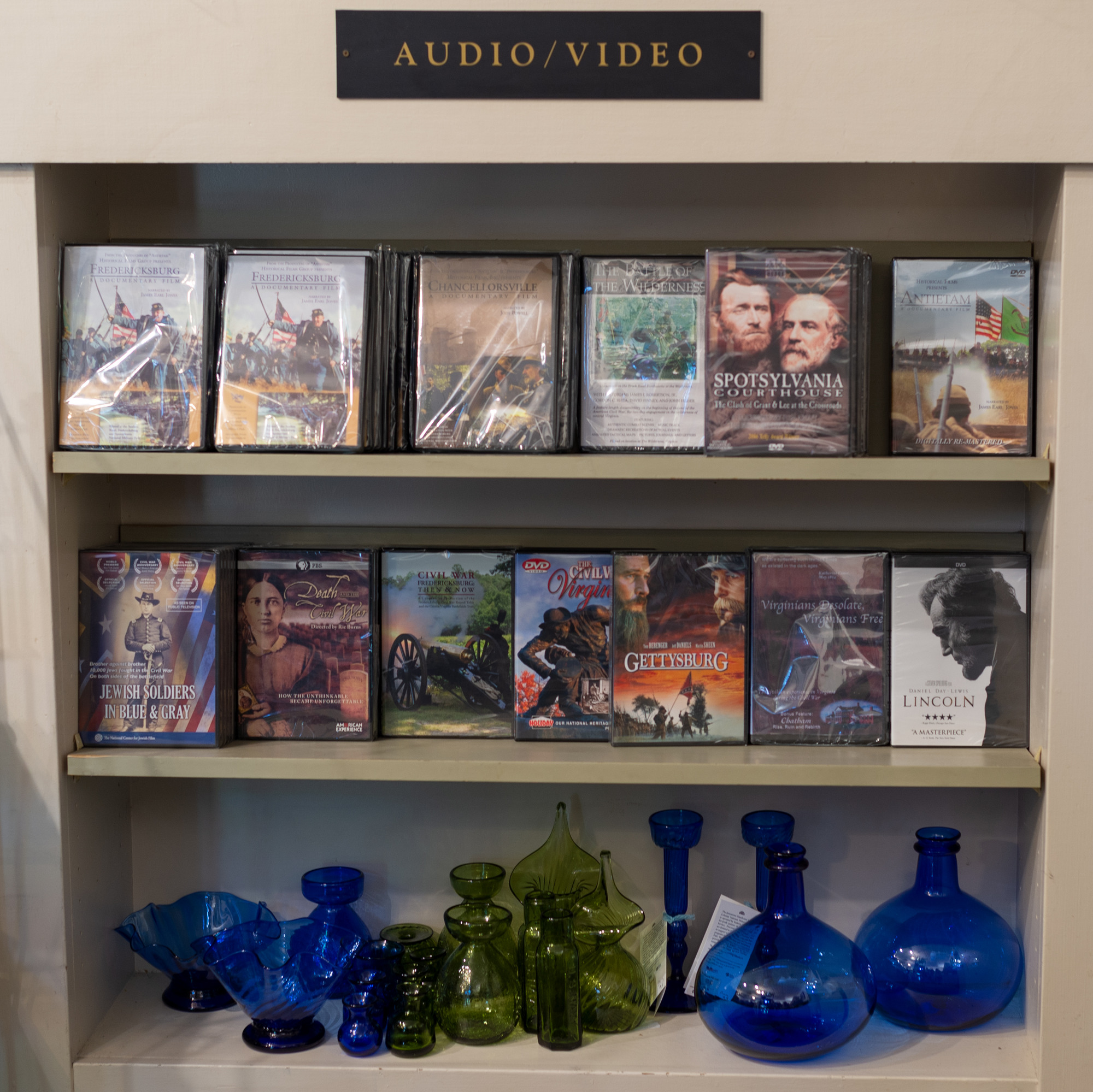 Movies and glassware in a gift shop.