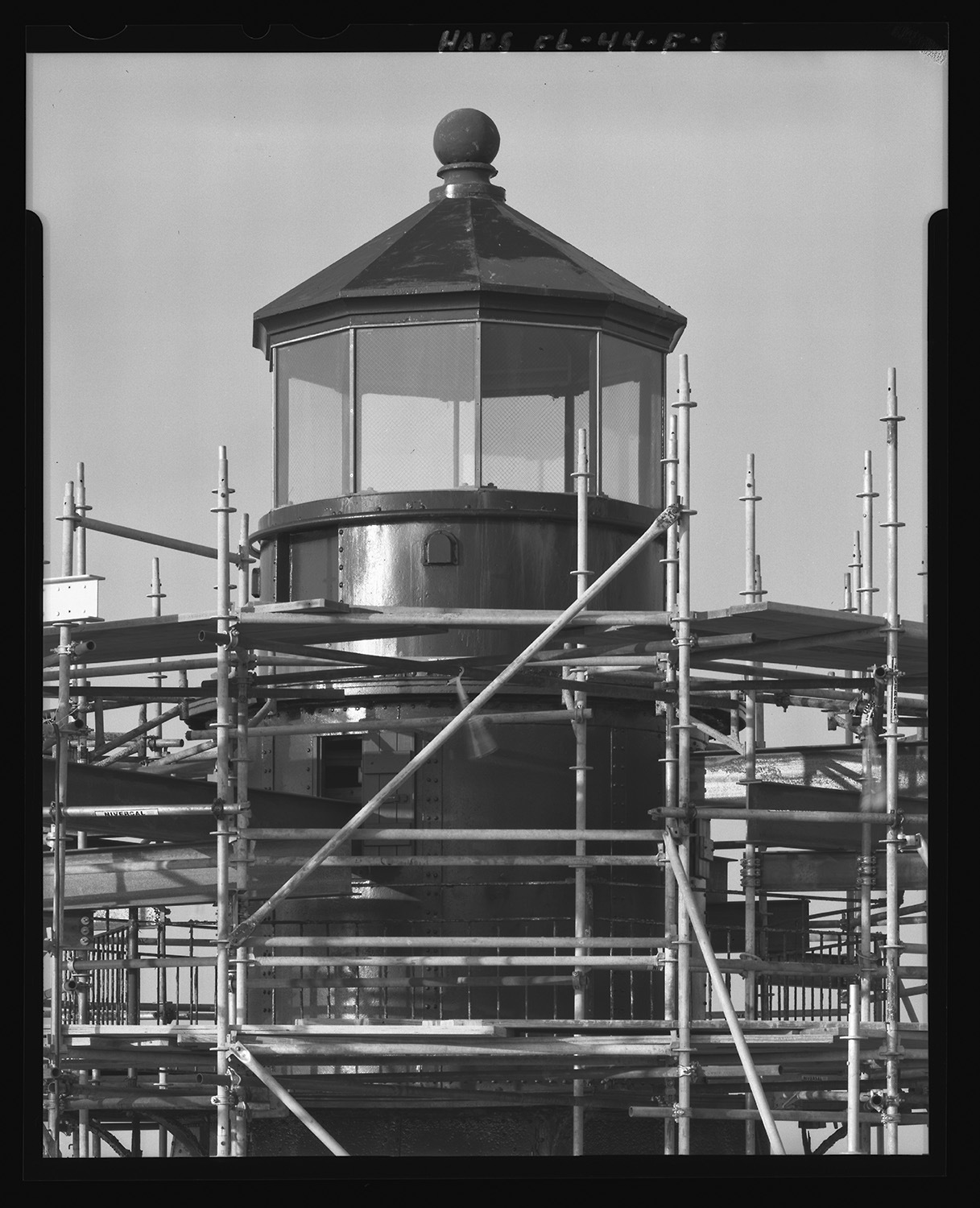 Black and white photograph of lighthouse lantern room exterior with scaffolding