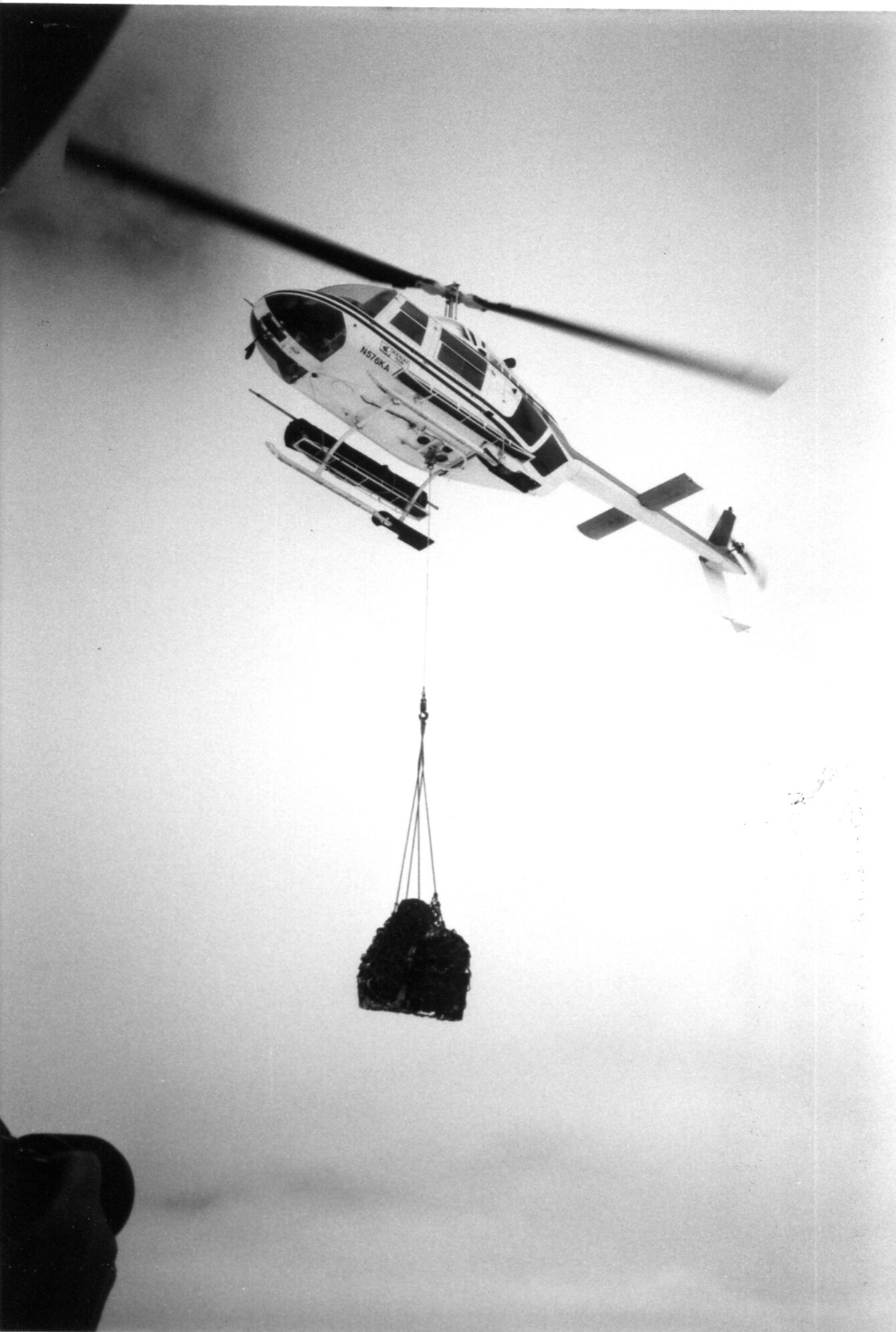 Kenai Air pilot Monte Hauk in a Belljet Ranger helicopter lifts a sling load at a research site on the Harding Icefield on June 9, 1985