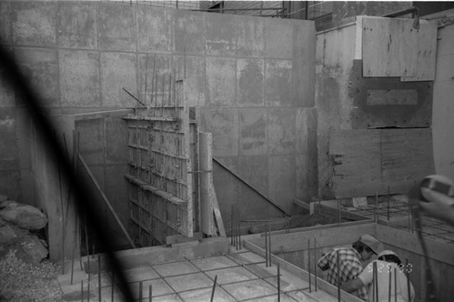 Workers performing construction duties during the construction of headquarters addition.