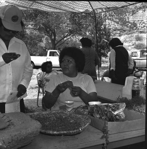 Woman with metate and basket of seeds in the third annual Folklife Festival at Zion National Park Nature Center, September 7-8, 1979.