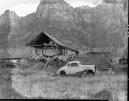 Samuel Heber and Mildred C. Crawford property east of Virgin River, south of park boundary, with sheds and old car.