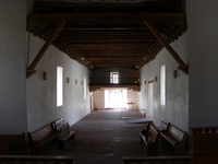 A long hallway with benches and windows.