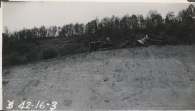 Carry wall on top of out slope, Station 40 showing flattening operation