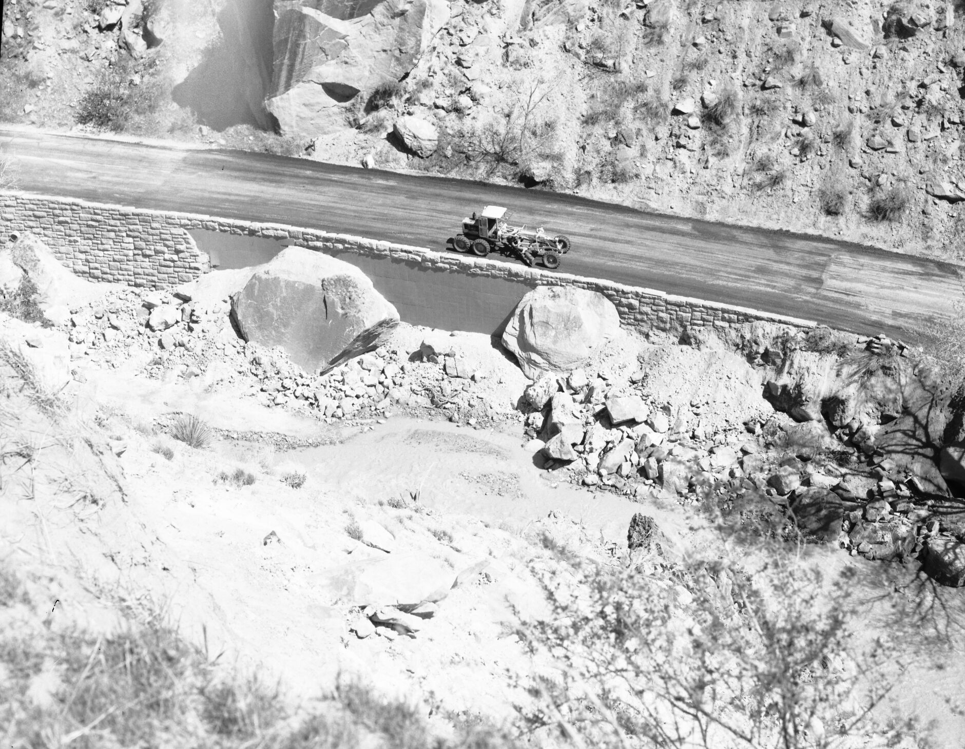 Flood damage repair - Zion Canyon, December 1966 flood. Grader fixing road between Birch Creek and Pine Creek on scenic drive.