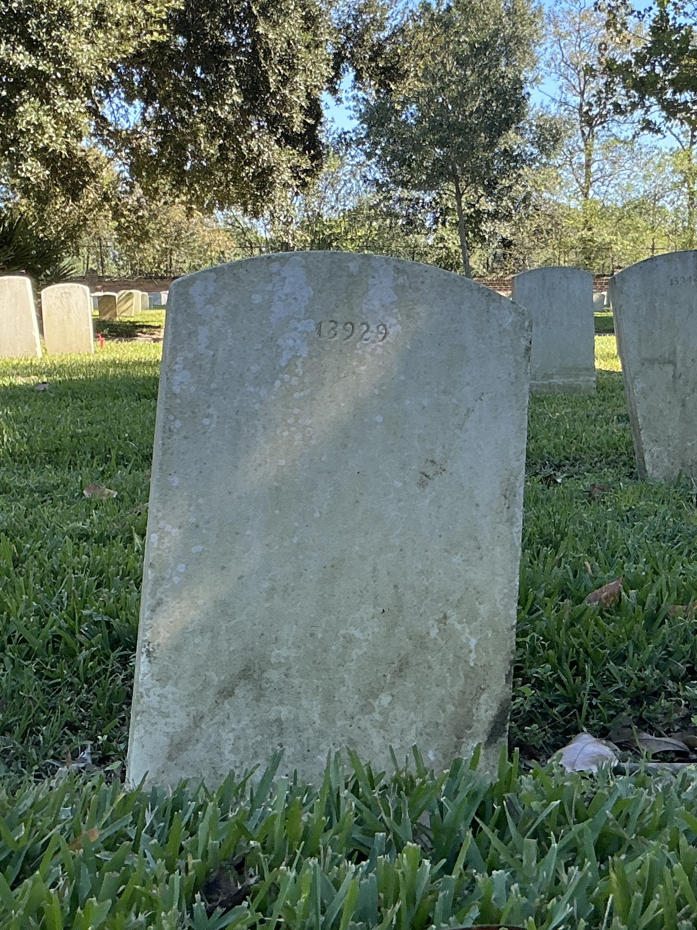 Back of upright marble headstone with flat face.