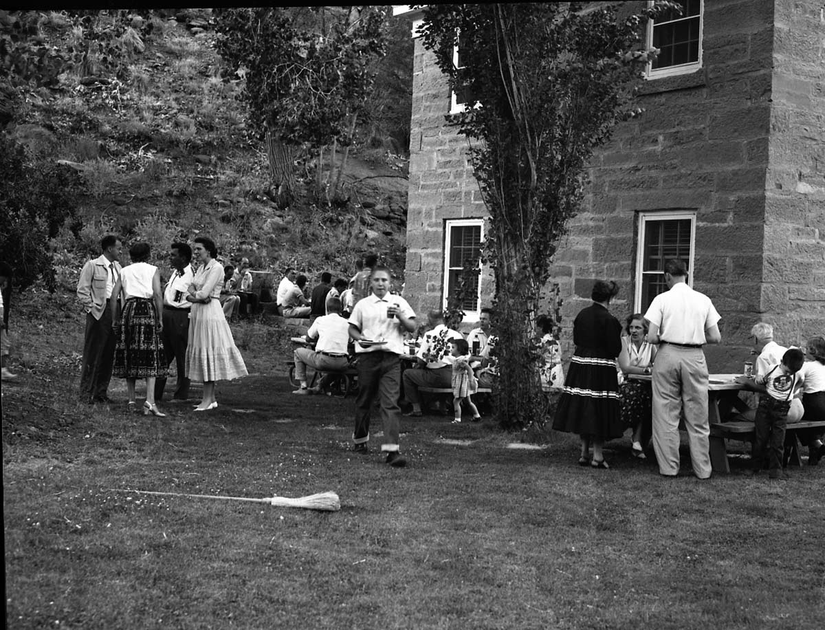 Barbecue picnic for seasonal staff. Employees, friends, and family socialize outside the ranger dormitory by park headquarters.