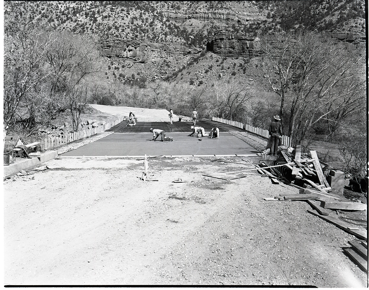 Oak Creek Bridge Construction troweling concrete bed.