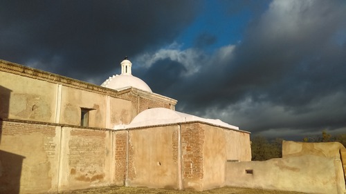 Tumacácori mission church, from east, white dome with stormy skies