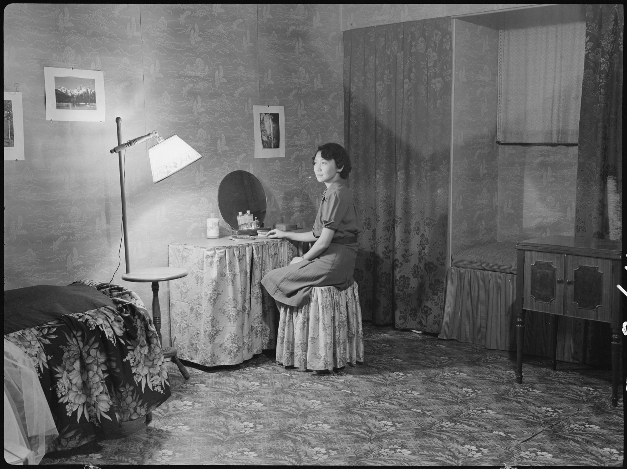 This apartment was very tastefully decorated and showed great originality in interior decoration. Blue was the dominant color in the room and was relieved by brightly colored couch covers and other spots of contrasting color. All of the material used in decorating this room was ordered by the evacuee through a mail order house