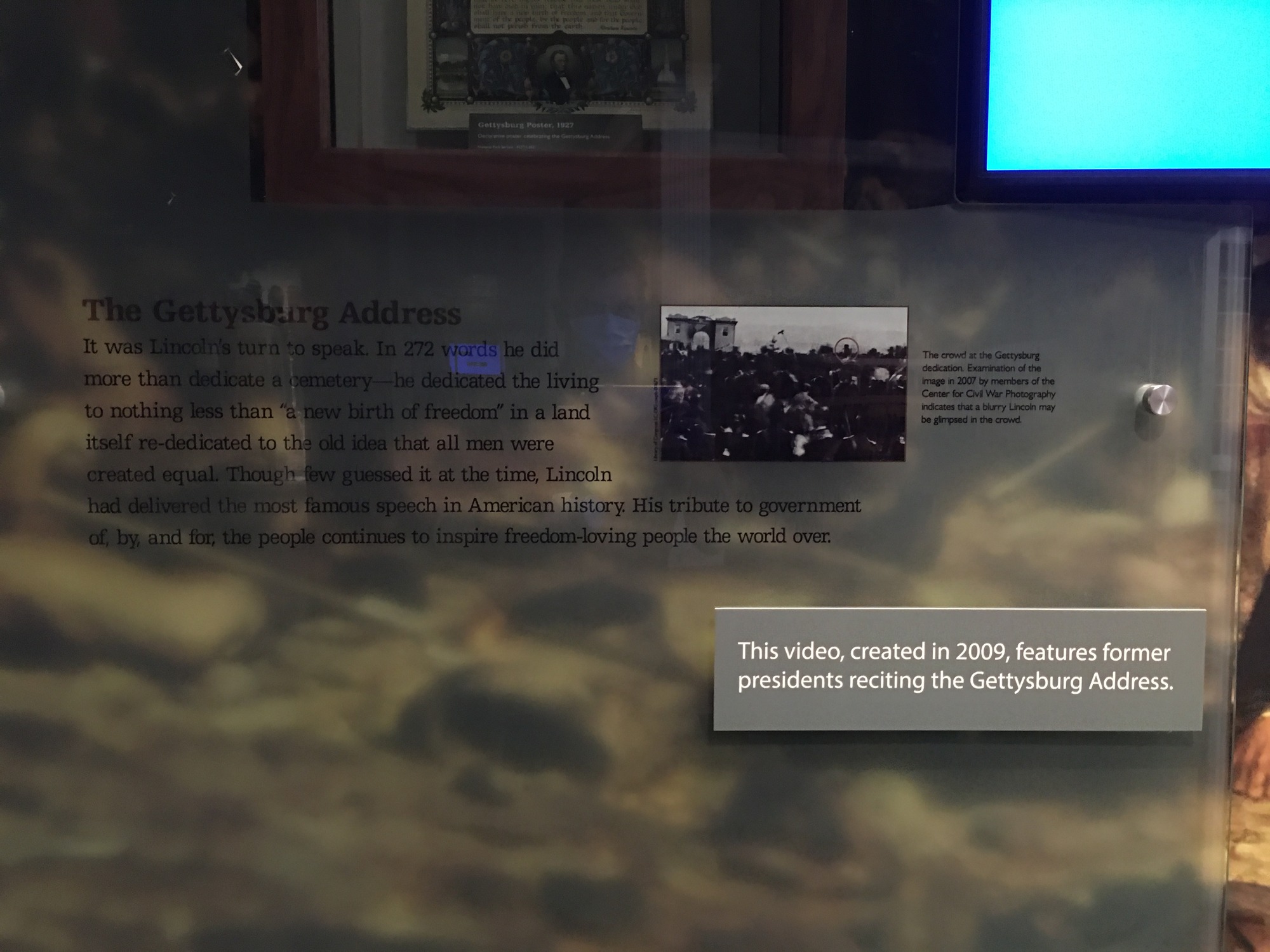 Text printed on a glass panel in front of a graphic mural are very hard to read. 