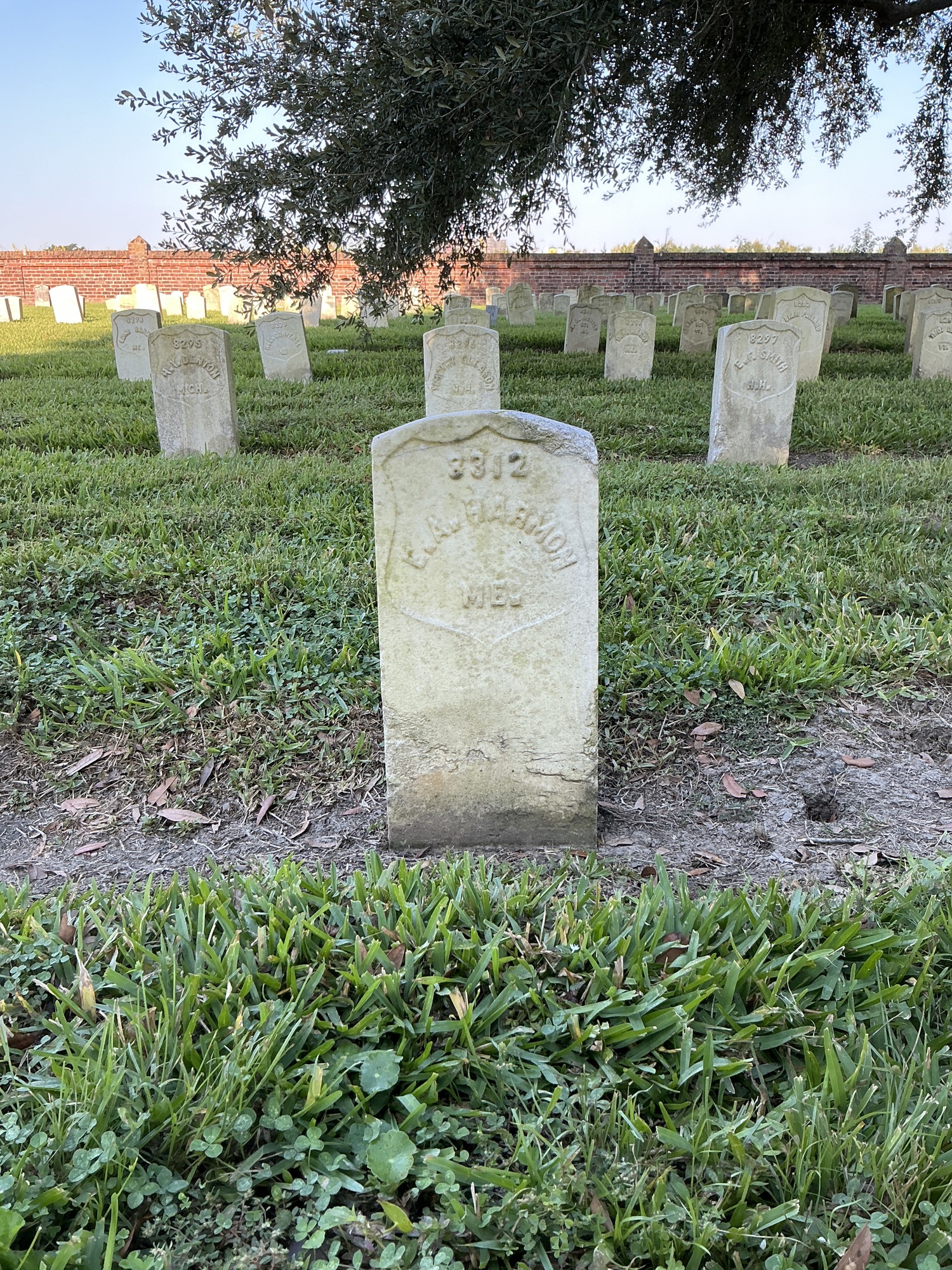 Front of historic upright marble headstone with recessed shield face.