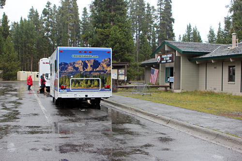 RVs parked at the entrance of the Fishing Bridge RV Park.