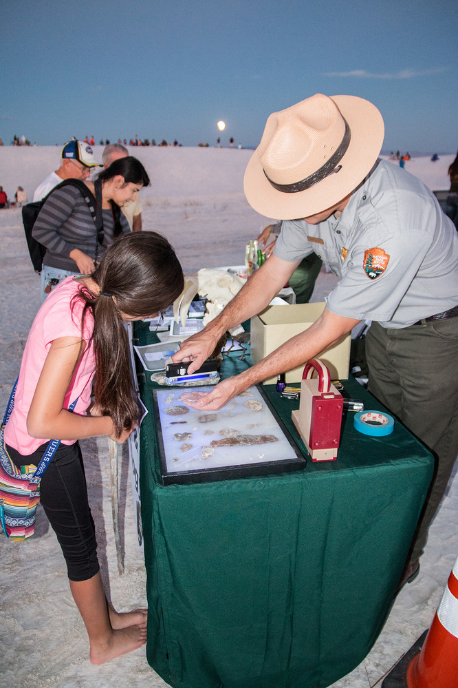 Rangers demonstrate the use of black light to locate root castings and other naturally occurring elements of the dunes during an evening event held at the park.