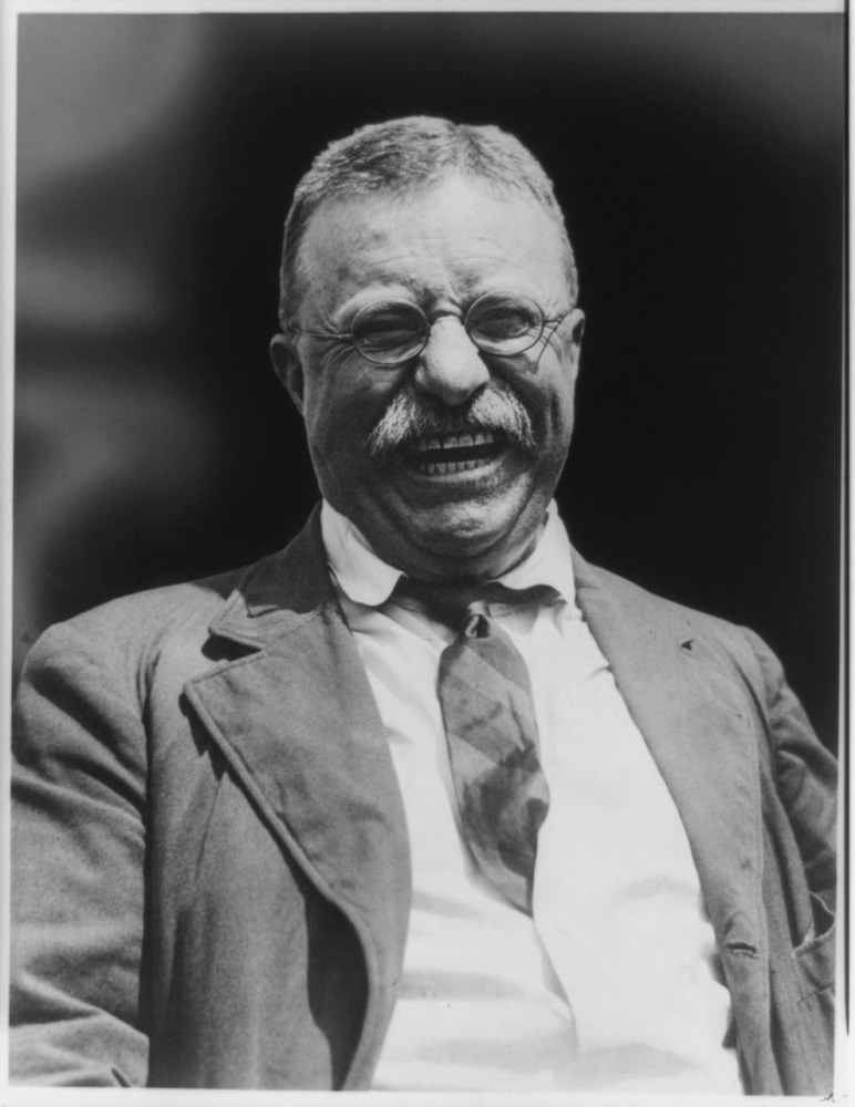 Theodore Roosevelt as president with a big laugh on his face