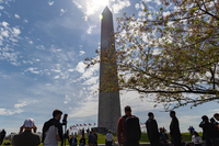 Visitors watch the partial eclipse over the Washington Monument 