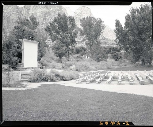 New amphitheater at South Campground, seats and screen, Watchman Housing Area visible through the trees.