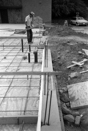 Man working on the construction of headquarters addition.